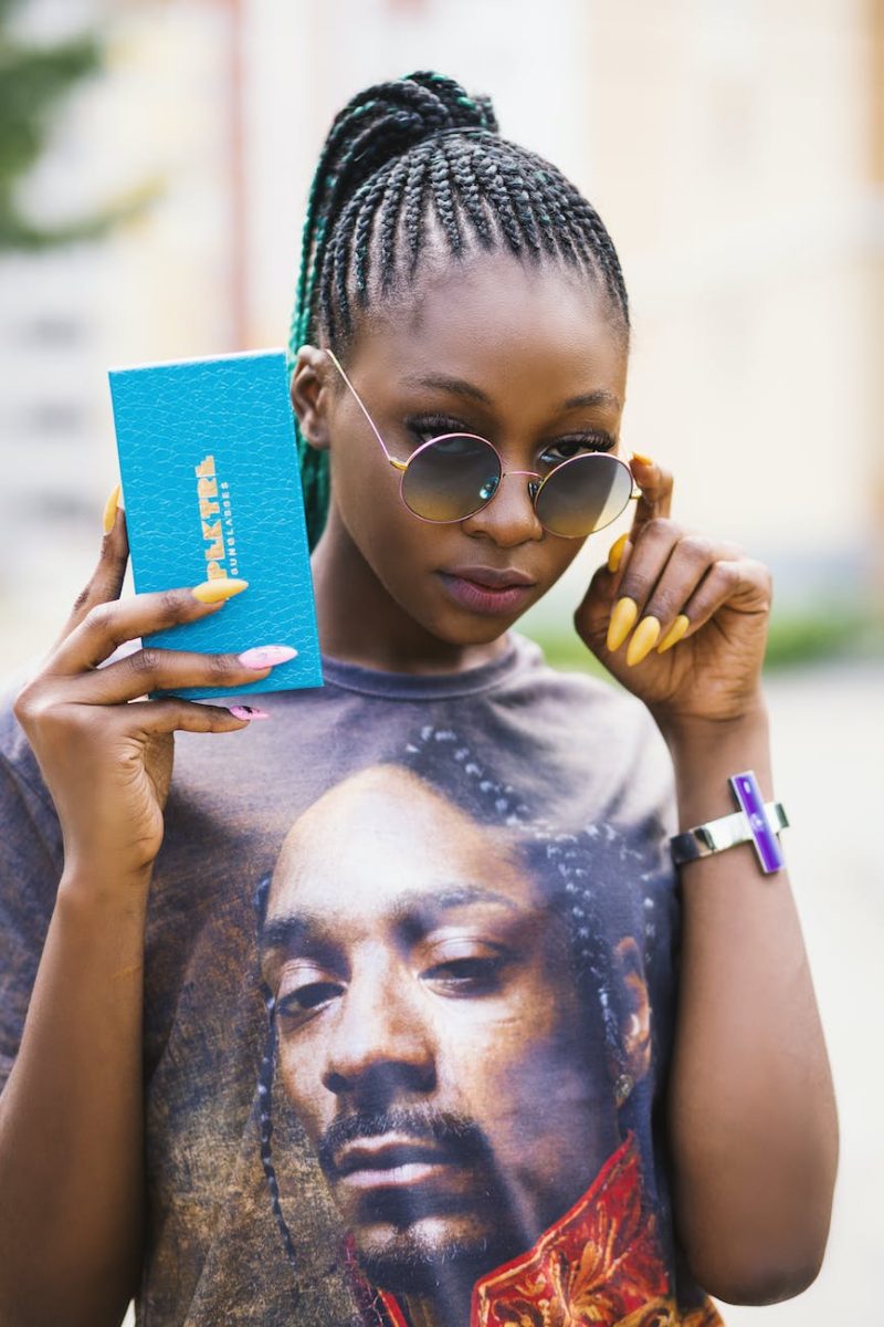 woman in black tee shirt holding blue case