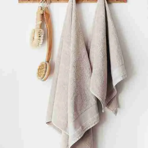 wooden hanger with towels and body brushes