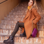 Woman in rust orange blazer with dark jeans and black platform boots - casual fall thanksgiving outfit idea